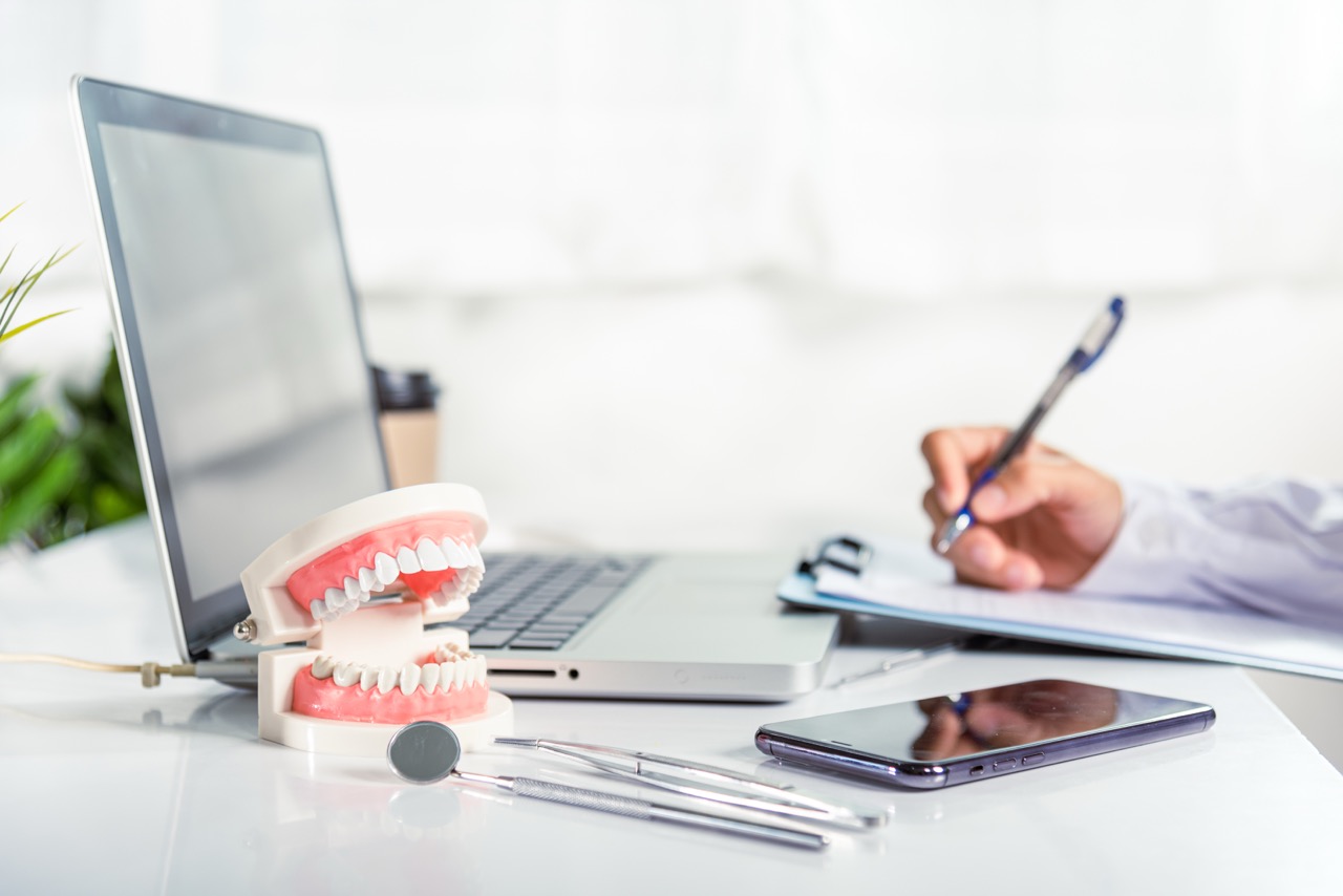 A dental professional completing paperwork